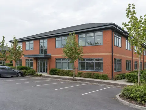 Two-storey red brick office building on a business park